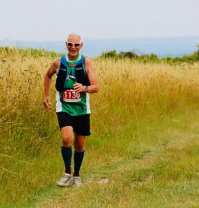 Alan Davies, running on a trail in the summer