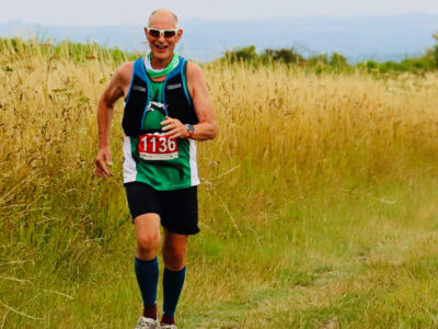 Alan Davies, running on a trail in the summer